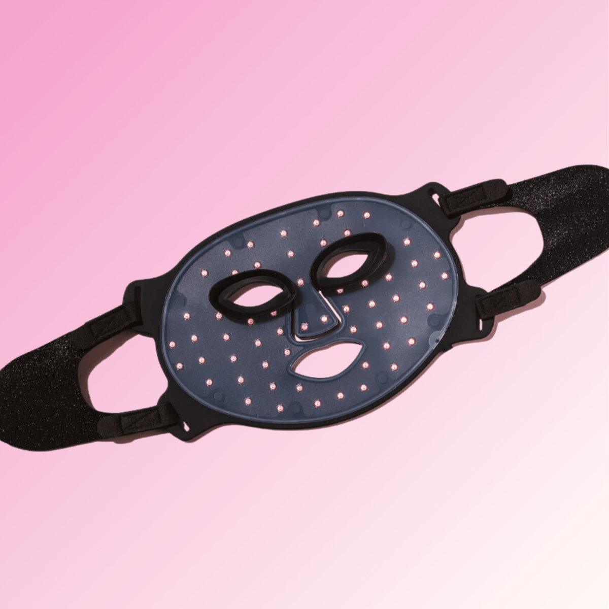 Silicone Infrared LED therapy mask on a pink background