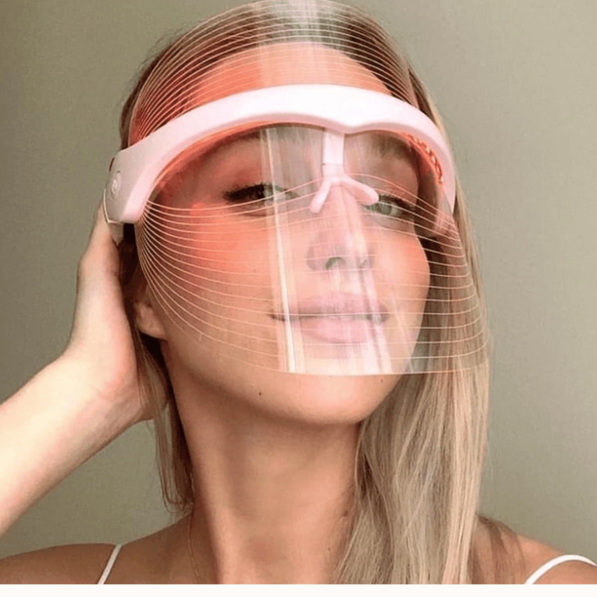 Women wearing the LED therapy mask with redlight turned on 